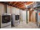 Basement laundry area with washer, dryer, and utility access at 8056 Meadowdale Sq, Niwot, CO 80503