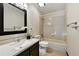 Neutral bathroom features a combined tub and shower, light tile, and modern vanity at 8056 Meadowdale Sq, Niwot, CO 80503