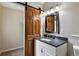 Modern bathroom features granite countertop, barn door to closet at 8056 Meadowdale Sq, Niwot, CO 80503