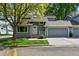 Charming home with blue siding, attached garage, and well-maintained landscaping at 8056 Meadowdale Sq, Niwot, CO 80503