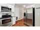 Bright kitchen features stainless steel appliances and white cabinetry at 8056 Meadowdale Sq, Niwot, CO 80503