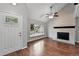 Bright living room with fireplace boasts hardwood floors, and a large window with neighborhood views at 8056 Meadowdale Sq, Niwot, CO 80503