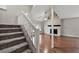 Open-concept living room with fireplace, wood floors, and staircase at 8056 Meadowdale Sq, Niwot, CO 80503