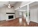 Spacious living room boasts a brick fireplace, wood floors, and a ceiling fan at 8056 Meadowdale Sq, Niwot, CO 80503