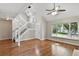 Bright living room boasts vaulted ceilings, ceiling fan, hardwood floors, and a large window with neighborhood views at 8056 Meadowdale Sq, Niwot, CO 80503