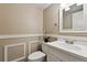 Classic powder room featuring neutral walls, modern white fixtures, and decorative wall trim at 8056 Meadowdale Sq, Niwot, CO 80503
