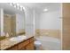 Clean bathroom featuring neutral tiling, a vanity with stone countertop and a bathtub with shower at 1950 N Logan St # 601, Denver, CO 80203