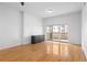 Bright bedroom featuring hardwood floors, a modern dresser, and sliding door to a private balcony at 1950 N Logan St # 601, Denver, CO 80203