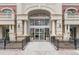 Exterior view of the building entrance with grand architectural details and landscaping at 1950 N Logan St # 601, Denver, CO 80203