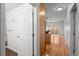 Open hallway connects to the open kitchen, featuring hardwood floors and neutral paint at 1950 N Logan St # 601, Denver, CO 80203