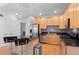 Spacious kitchen with stainless steel appliances, black countertops, and seating at the kitchen island at 1950 N Logan St # 601, Denver, CO 80203