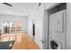 Bright living room featuring hardwood floors and a sliding glass door to a private balcony, plus a laundry closet at 1950 N Logan St # 601, Denver, CO 80203