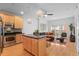 Open-concept living space with island kitchen, hardwood floors, and comfortable seating near private balcony at 1950 N Logan St # 601, Denver, CO 80203