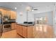 Bright open-concept living space featuring hardwood floors, island kitchen, and private balcony at 1950 N Logan St # 601, Denver, CO 80203