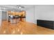 Living area featuring hardwood floors adjacent to kitchen; plenty of space with modern lighting at 1950 N Logan St # 601, Denver, CO 80203