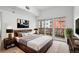 Cozy main bedroom featuring a warm aesthetic with an adjacent private balcony at 1950 N Logan St # 601, Denver, CO 80203