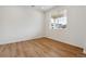 Bright bedroom featuring hardwood floors, white walls and trim, and a large window to let in natural light at 9652 Cathay St, Commerce City, CO 80022