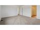 Open bedroom with plush carpeting, connecting to the ensuite bath, providing space and comfort at 9652 Cathay St, Commerce City, CO 80022