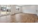 Open-concept living room with hardwood floors, large windows, and sliding doors for natural light and easy outdoor access at 9652 Cathay St, Commerce City, CO 80022