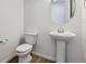 Modern half-bathroom with a pedestal sink, updated fixtures, and stylish decor at 9652 Cathay St, Commerce City, CO 80022