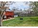 An expansive backyard features a green lawn, a deck, string lights, and an outdoor entertaining area at 4303 S Yank St, Morrison, CO 80465