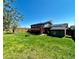 View of a large backyard with green grass, a deck, disc golf target, and solar panels at 4303 S Yank St, Morrison, CO 80465