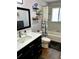 Stylish bathroom featuring a modern vanity, a tiled shower-tub, and sleek fixtures at 4303 S Yank St, Morrison, CO 80465