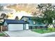 Charming two-story home with a well-maintained lawn and a two car garage at 4303 S Yank St, Morrison, CO 80465