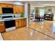 Bright kitchen featuring wood cabinets and seamlessly flowing into the dining area at 4303 S Yank St, Morrison, CO 80465