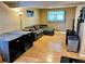 Spacious living room featuring gray sofa, wood flooring, and large windows at 4303 S Yank St, Morrison, CO 80465