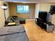 Comfortable living room features wood floors, gray sectional, and entertainment area at 4303 S Yank St, Morrison, CO 80465