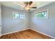 Cozy bedroom featuring hardwood floors, two windows offering natural light, and neutral gray walls at 2497 S Race St, Denver, CO 80210