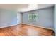 Bright living room featuring gleaming hardwood floors, neutral paint, and natural light from a large window at 2497 S Race St, Denver, CO 80210