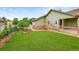 Expansive backyard with a well-manicured lawn and charming garden beds, perfect for outdoor activities at 5193 Rustic Ave, Firestone, CO 80504