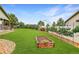 Spacious backyard with lush lawn, garden beds, privacy fence and mature landscaping at 5193 Rustic Ave, Firestone, CO 80504