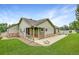 Spacious backyard featuring a covered porch and a stone facade, perfect for outdoor entertaining at 5193 Rustic Ave, Firestone, CO 80504