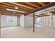 Unfinished basement space with exposed wood beams and a window for natural light at 5193 Rustic Ave, Firestone, CO 80504
