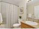 Well-lit bathroom features a shower with curtain, vanity, and neutral color palette at 5193 Rustic Ave, Firestone, CO 80504