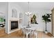 Bright dining area featuring a modern chandelier, white table and hardwood floors at 5193 Rustic Ave, Firestone, CO 80504