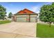 Charming home featuring a three-car garage, stone accents, and well-maintained landscaping at 5193 Rustic Ave, Firestone, CO 80504