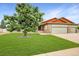 Beautiful home with a lush green lawn and a mature tree in the front yard at 5193 Rustic Ave, Firestone, CO 80504