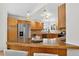 Spacious kitchen featuring granite countertops, wooden cabinets and stainless steel appliances at 5193 Rustic Ave, Firestone, CO 80504
