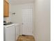 Functional laundry room with washer, dryer, and cabinet space at 5193 Rustic Ave, Firestone, CO 80504
