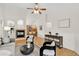 Open-concept living room featuring a fireplace, hardwood floors, and stylish furnishings at 5193 Rustic Ave, Firestone, CO 80504