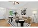 Inviting living room featuring hardwood floors, large windows, and stylish decor at 5193 Rustic Ave, Firestone, CO 80504