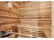 Inviting wooden sauna with bench seating and a thermometer, promising relaxation at 5193 Rustic Ave, Firestone, CO 80504