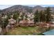 Aerial view showcasing homes with mature trees, lush yards, and mountain views at 25 High St, Palmer Lake, CO 80133