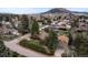An aerial view of a neighborhood showcasing well-maintained homes and mature trees at 25 High St, Palmer Lake, CO 80133