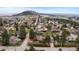 Scenic aerial view of a neighborhood with tree-lined streets, homes, and a mountain in the background at 25 High St, Palmer Lake, CO 80133