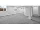 Spacious finished basement area with modern gray carpeting and bright white walls at 25 High St, Palmer Lake, CO 80133